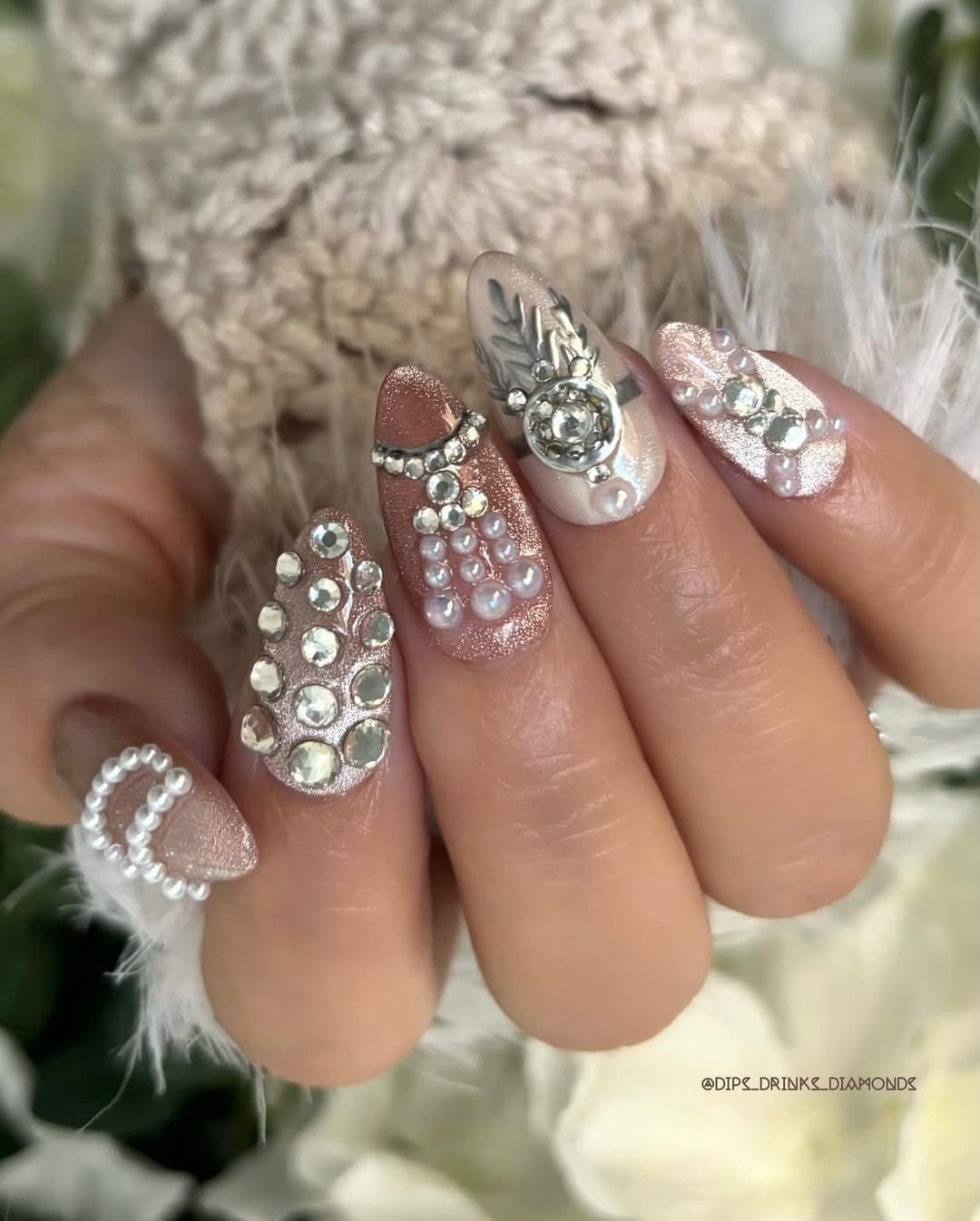 White nails with glitter and rhinestone embellishments