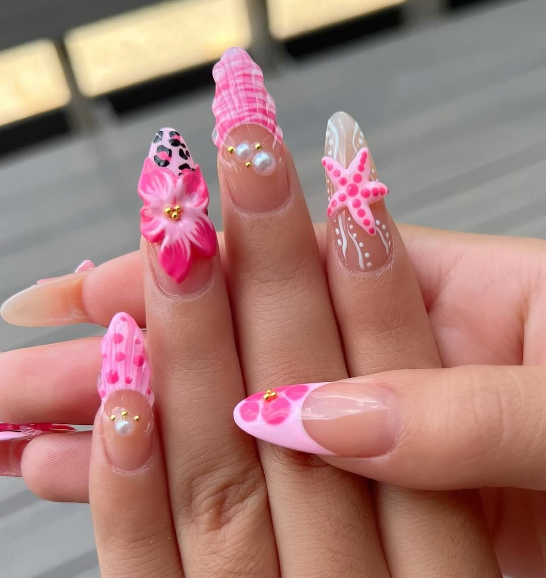 Detailed hot pink nails with floral designs