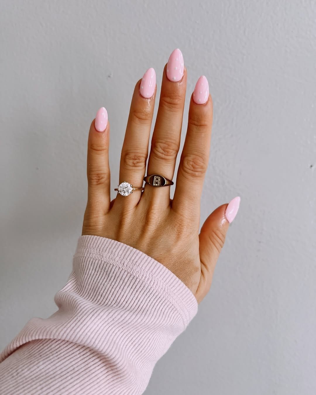 Light pink nails with white polka dots