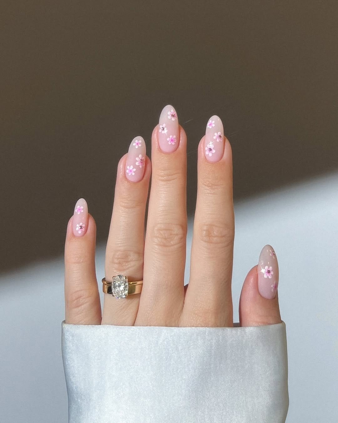 Cherry blossom-themed nails with pink and white flowers
