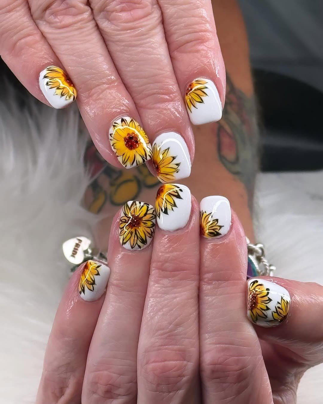 Bright sunflower nail art on a white background