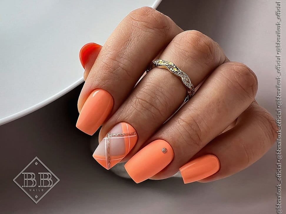 Soft peach nails with white floral accents
