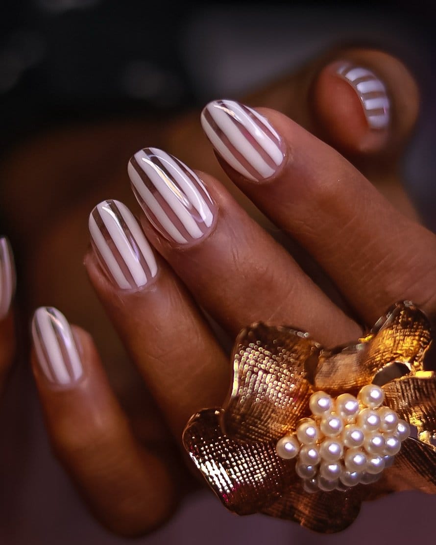 White nails with metallic stripes