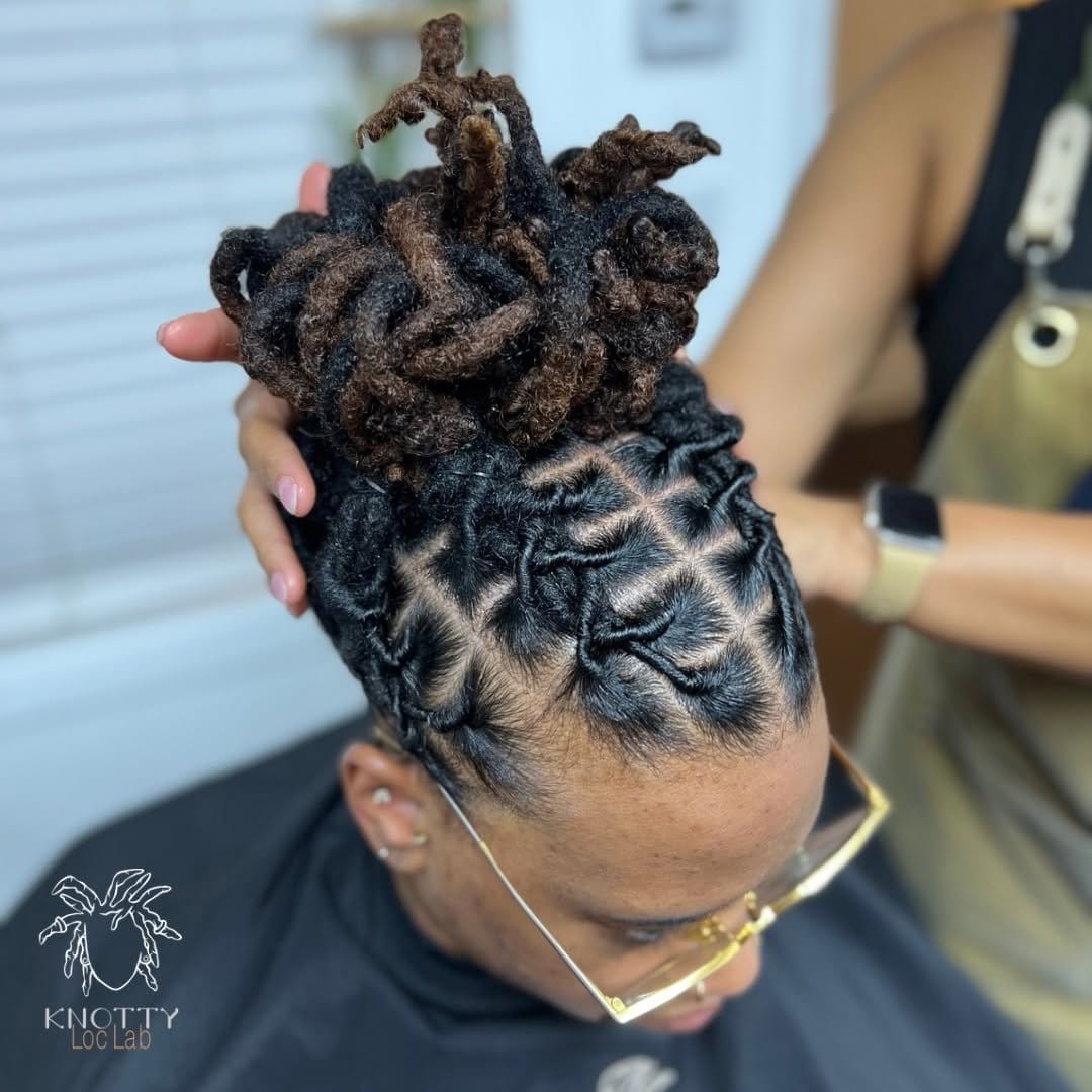 Short dreadlocks styled in a neat bun