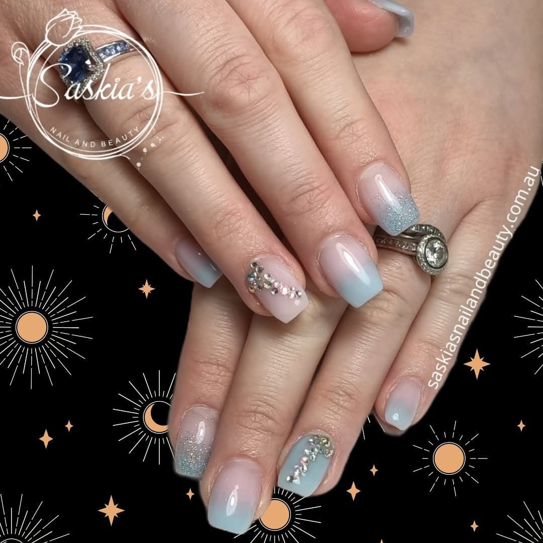 Icy pastel blue nails with silver flakes
