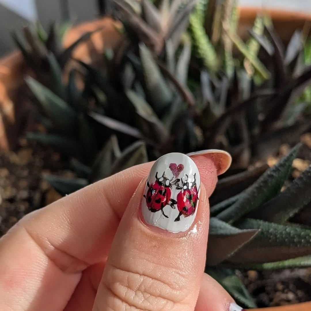 Red and black ladybug nail art