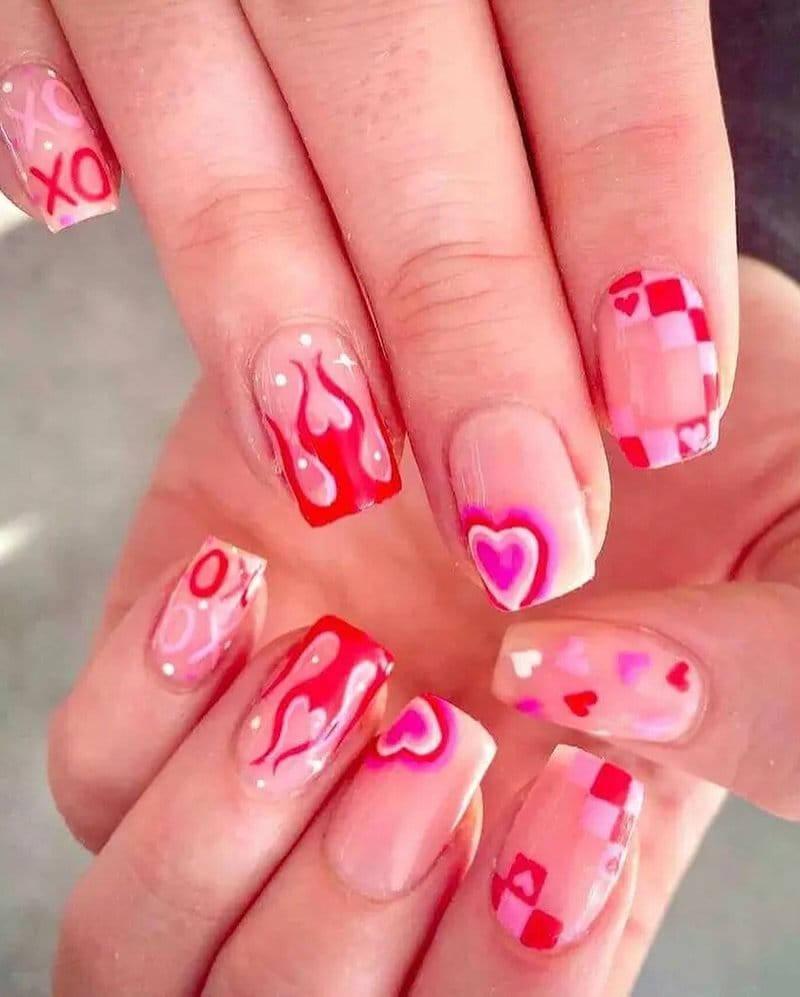 Red nails with tiny white heart patterns