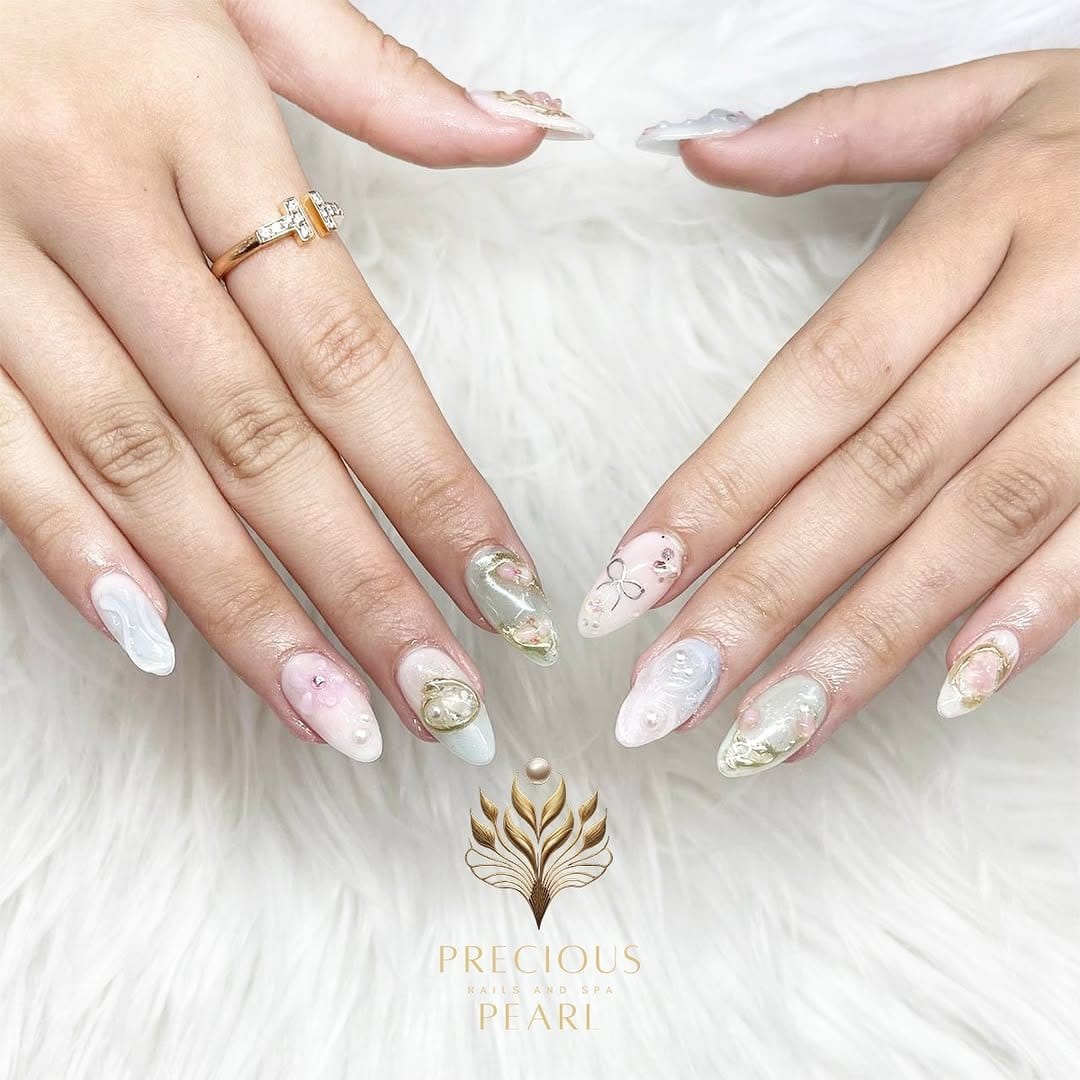 Light pink nails with gold leaf accents