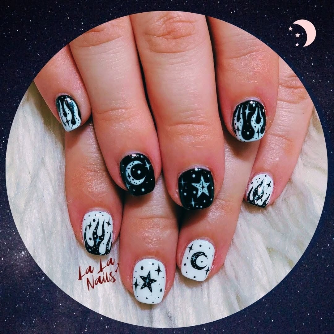 Celestial pastel pink nails with moon and star designs
