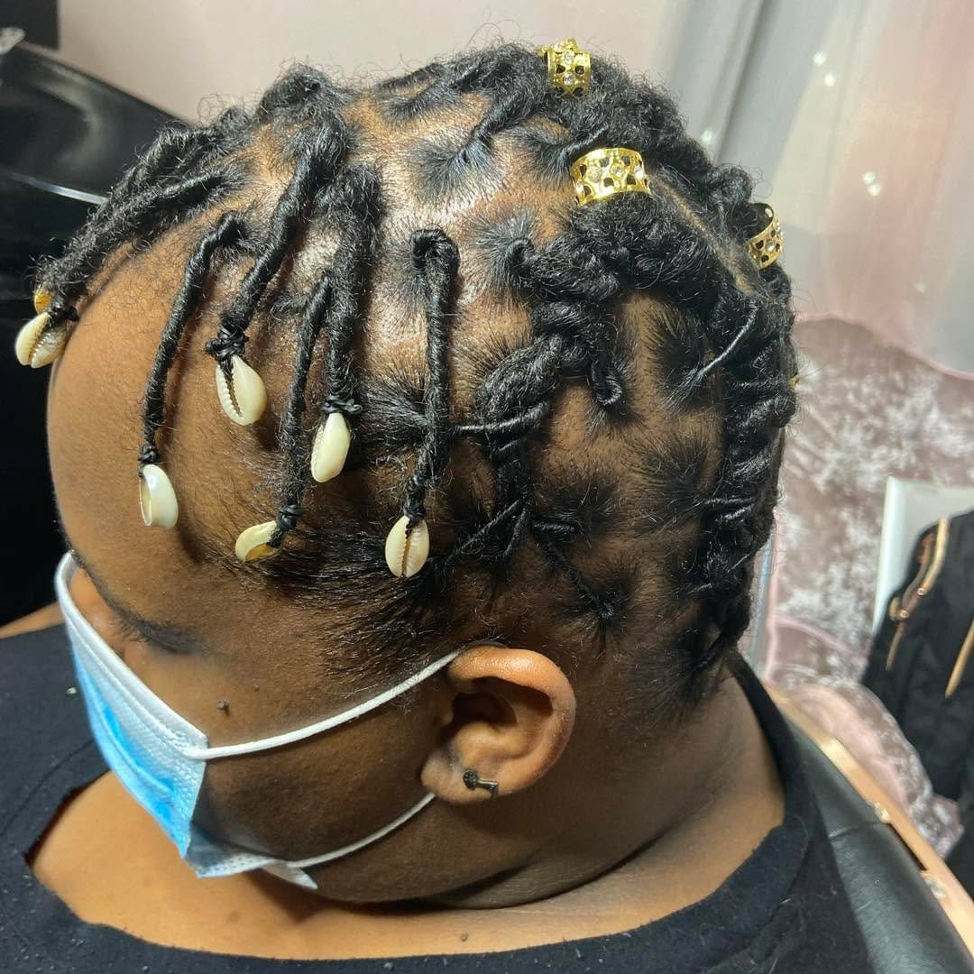Short dreadlocks adorned with colorful beads
