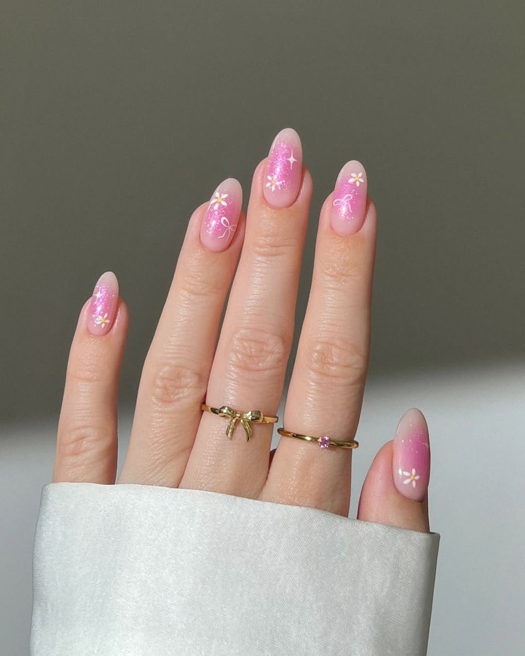 Pastel rose pink nails with petal designs
