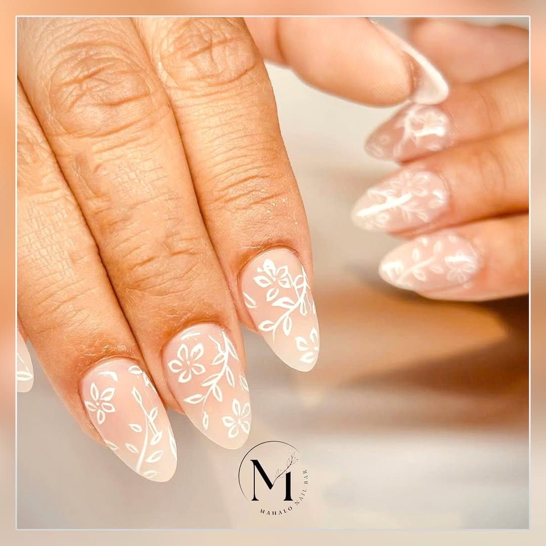 Swirled pastel nail design with floral elements
