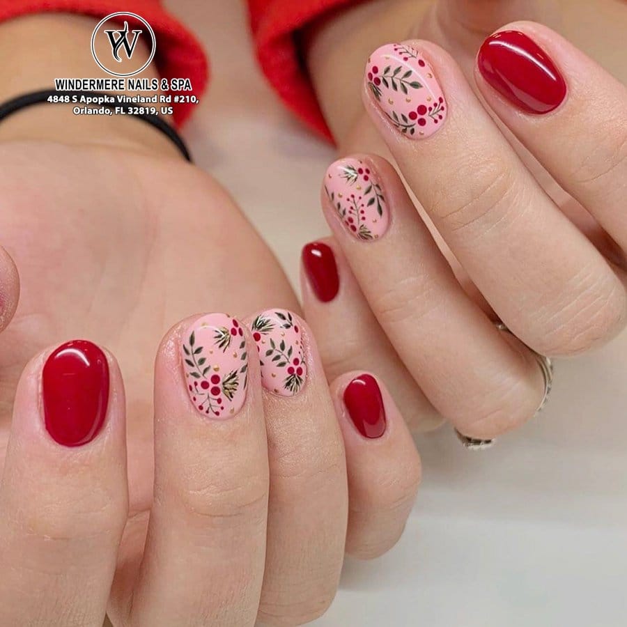 Bright red nails with delicate white floral designs