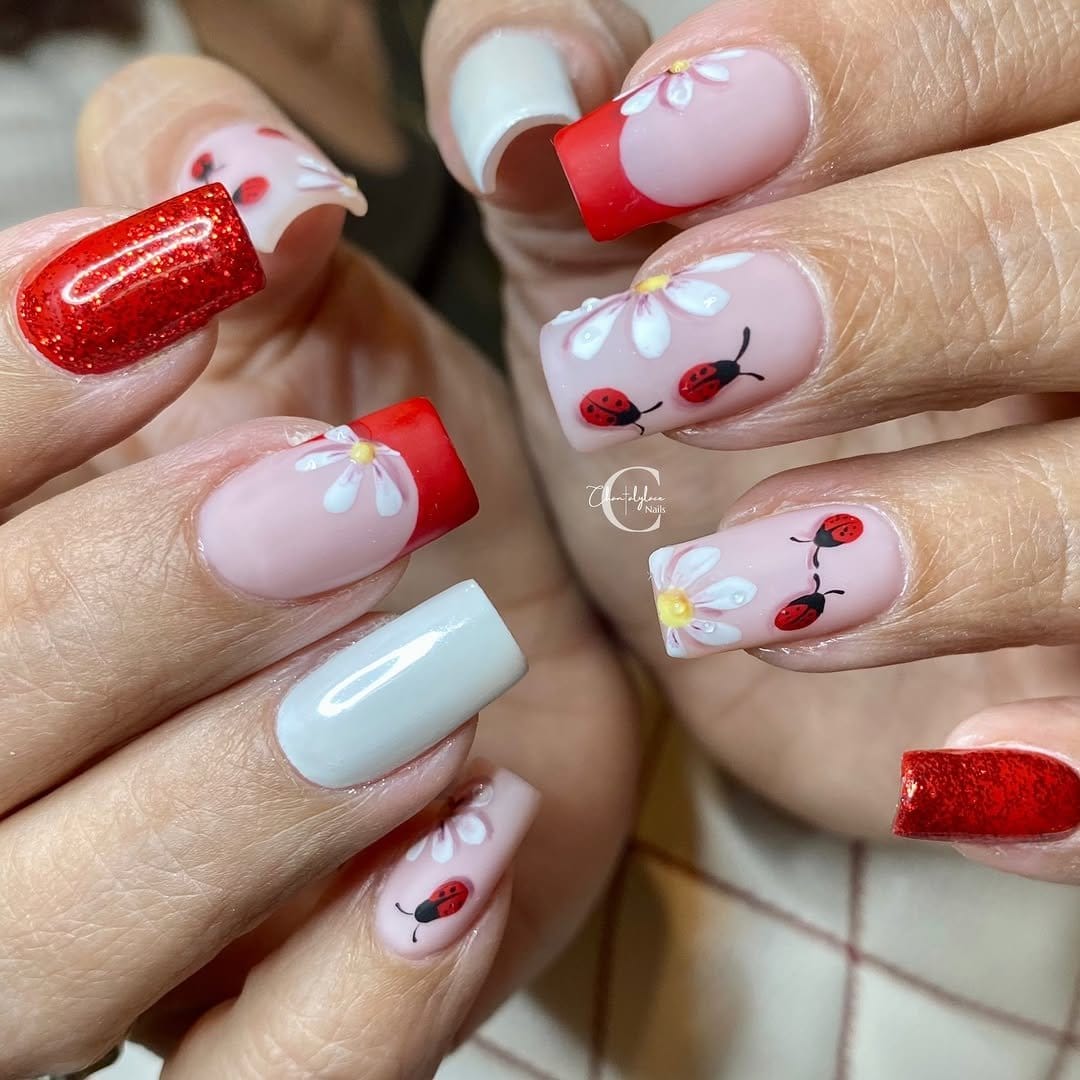 Vibrant poppy nail art on a bold red background