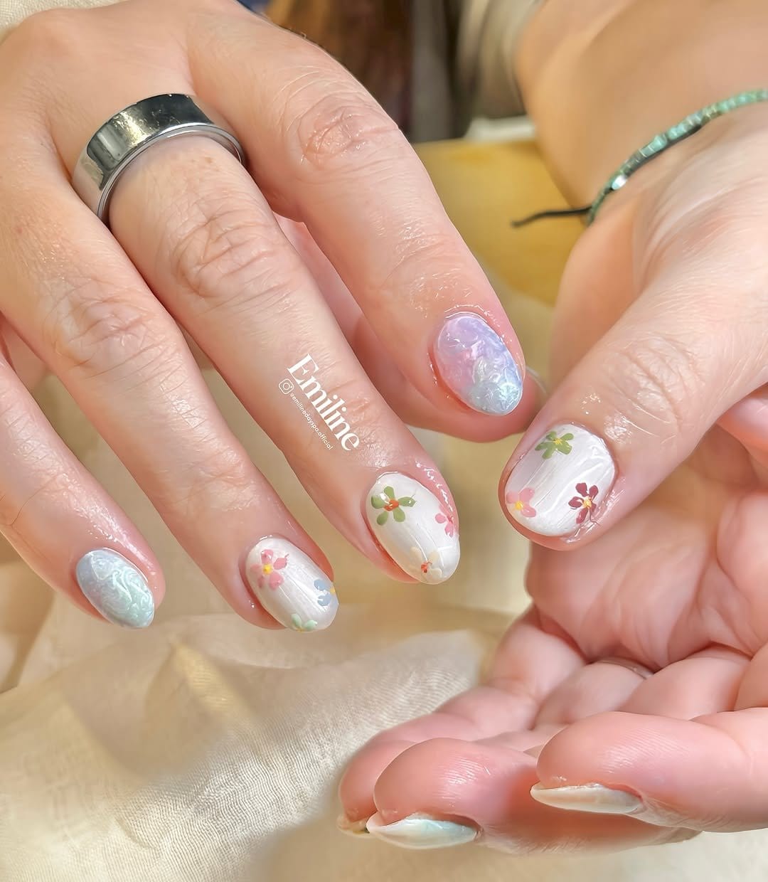 Tiny floral nail art in soft pastels
