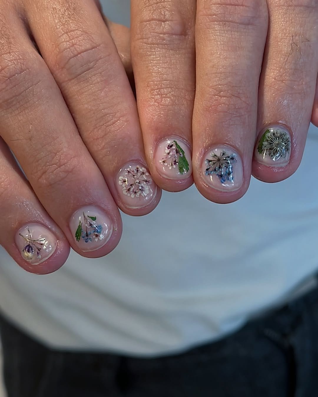 Freesia flower nail art on a white background