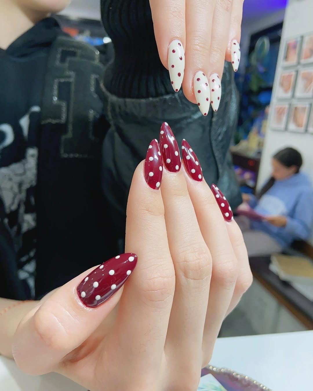 Red nails with white polka dots