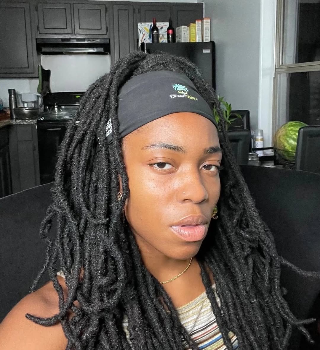 Short dreadlocks styled with a headband