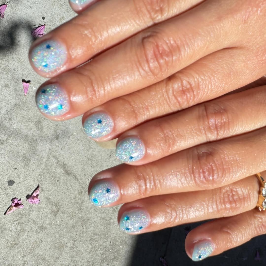Ethereal pastel blue ombre nails with stars