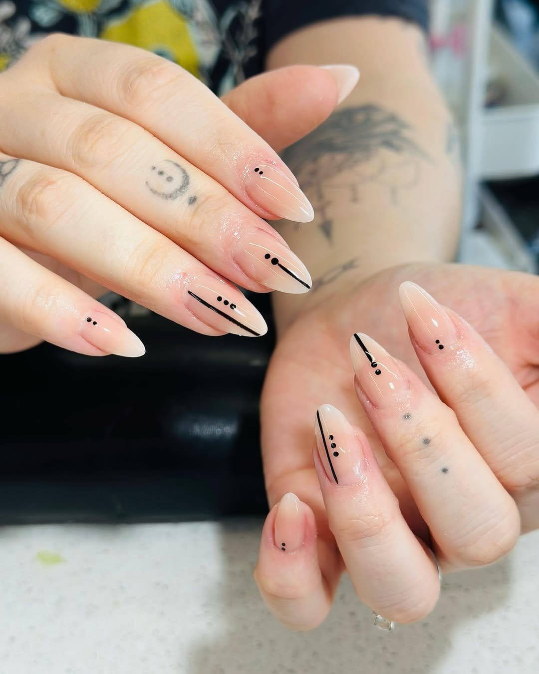 Single dot minimalist nail art on nude nails