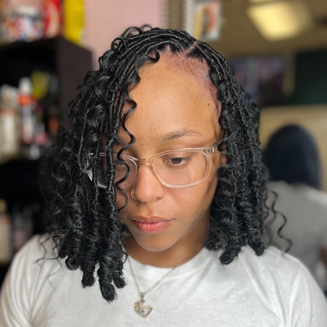 Woman with side-parted short locs