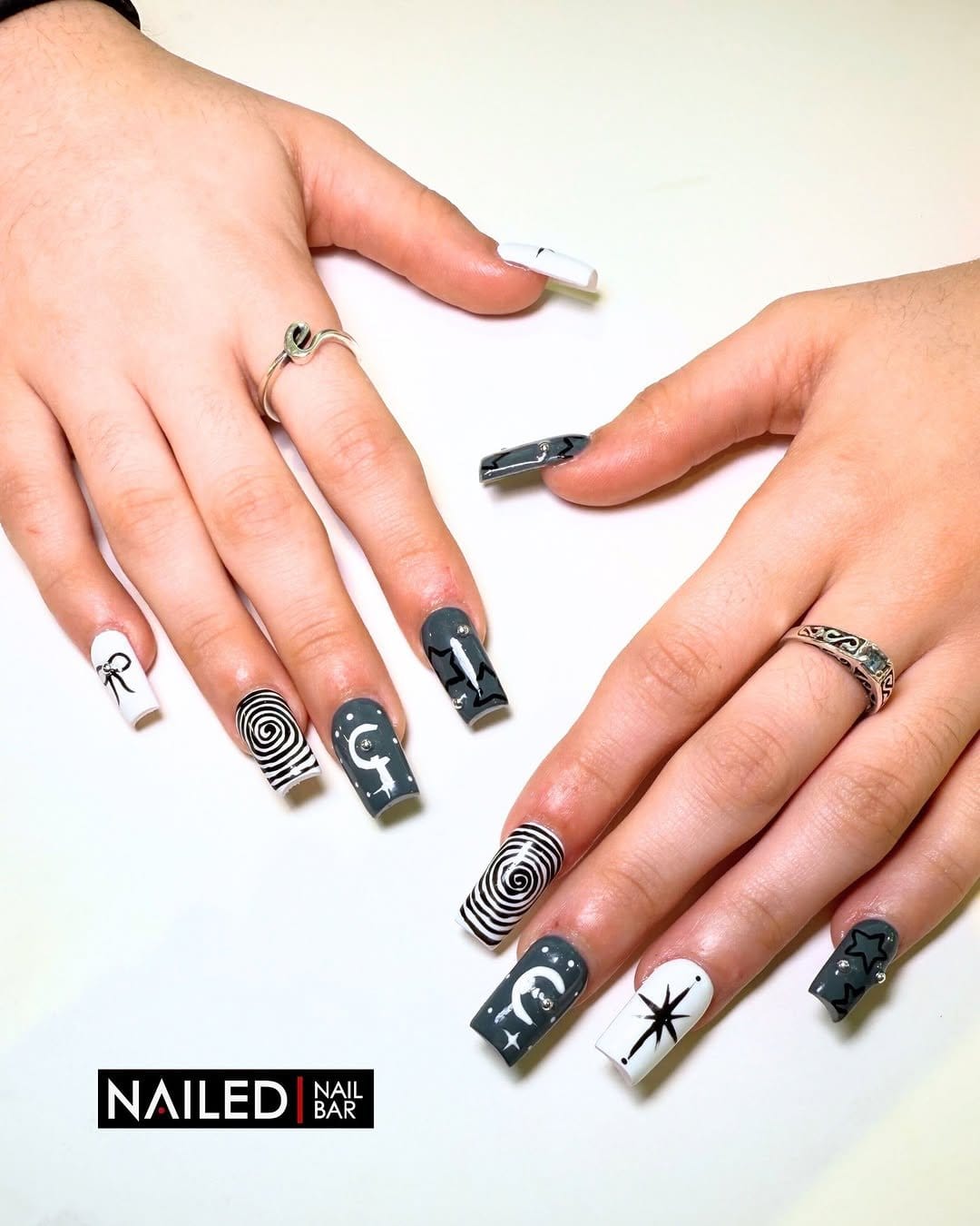 Nails with moon phase designs on a nude base