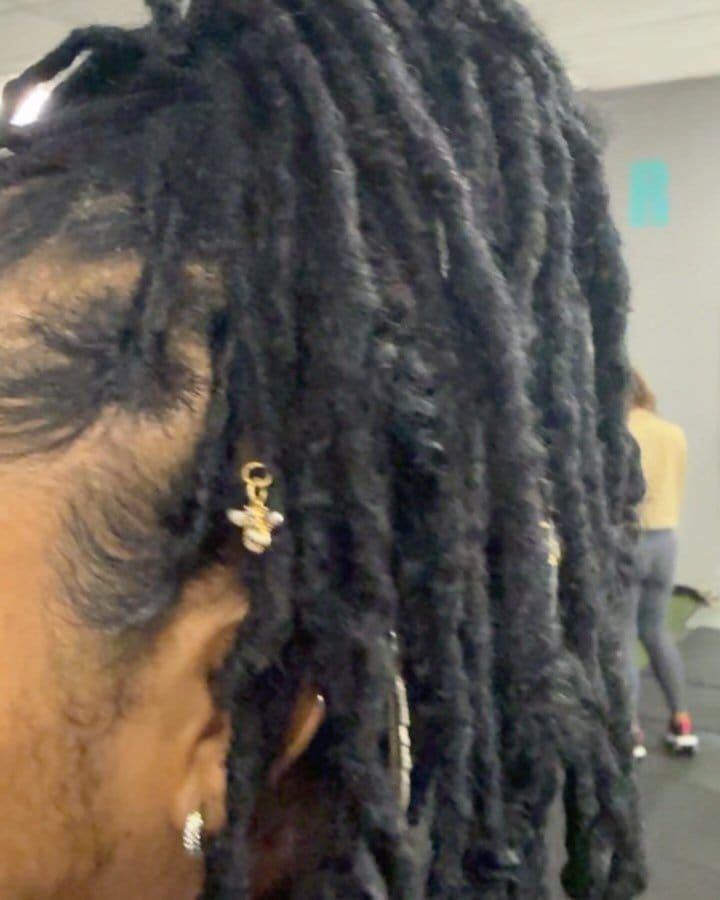 Short locs adorned with beads and charms