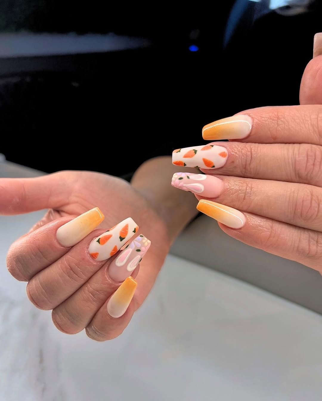 Delicate pastel peach ombre nails with a peach in hand