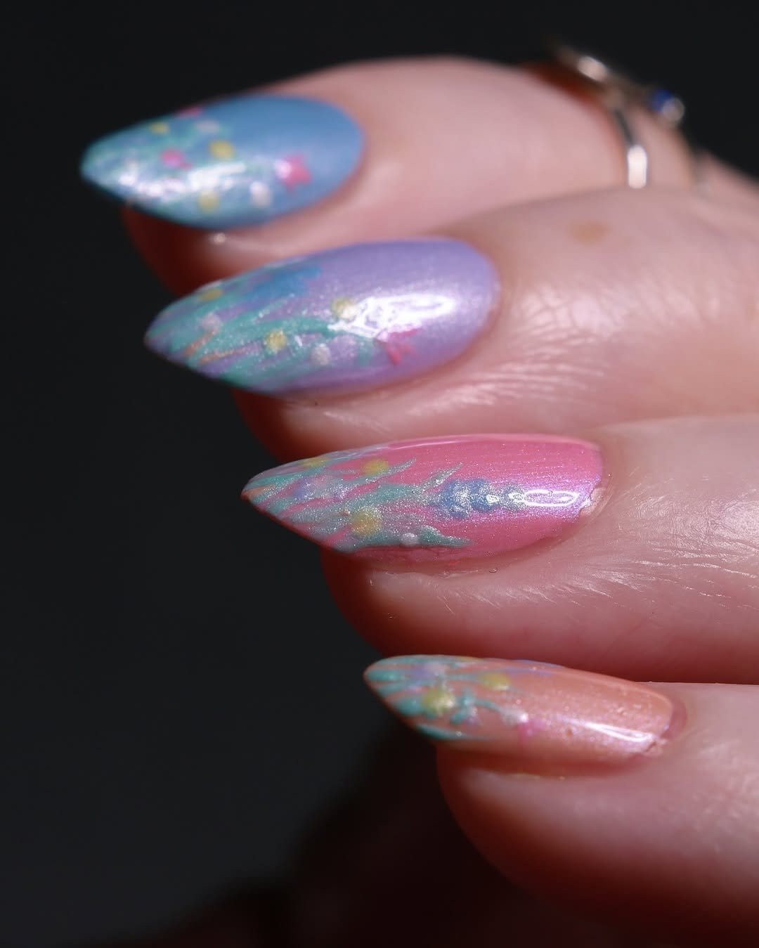 Nails with floral water decals on a pastel background