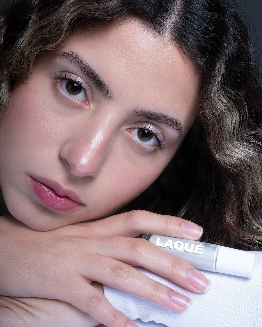 Model applying cream highlighter