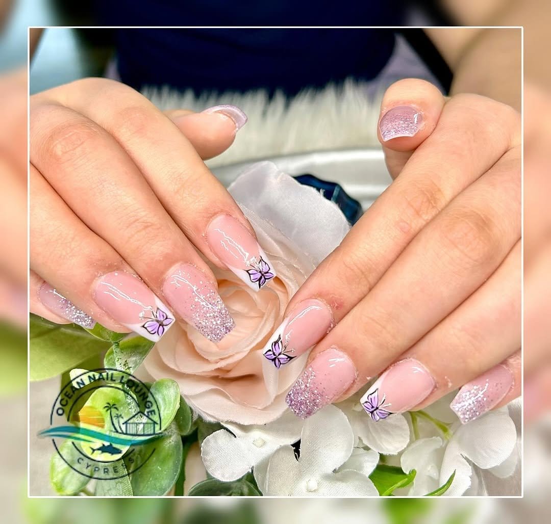 White nails with glitter butterfly accents