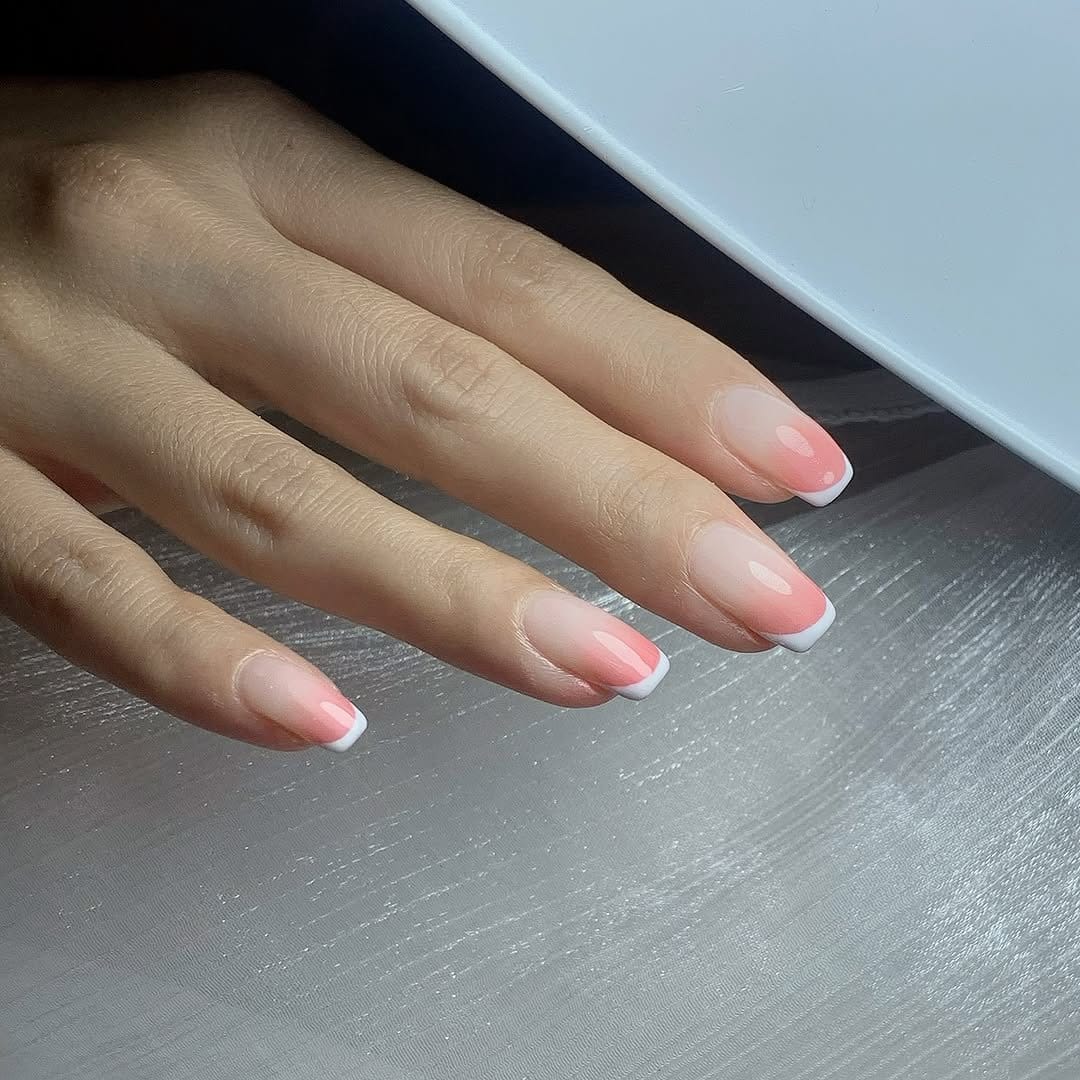 Classic pink ombre nails on a hand