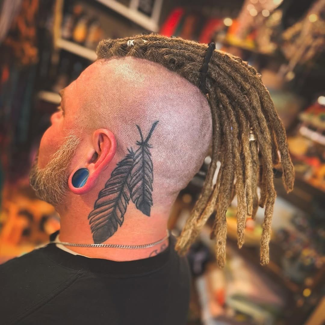 Short locs with feather decorations