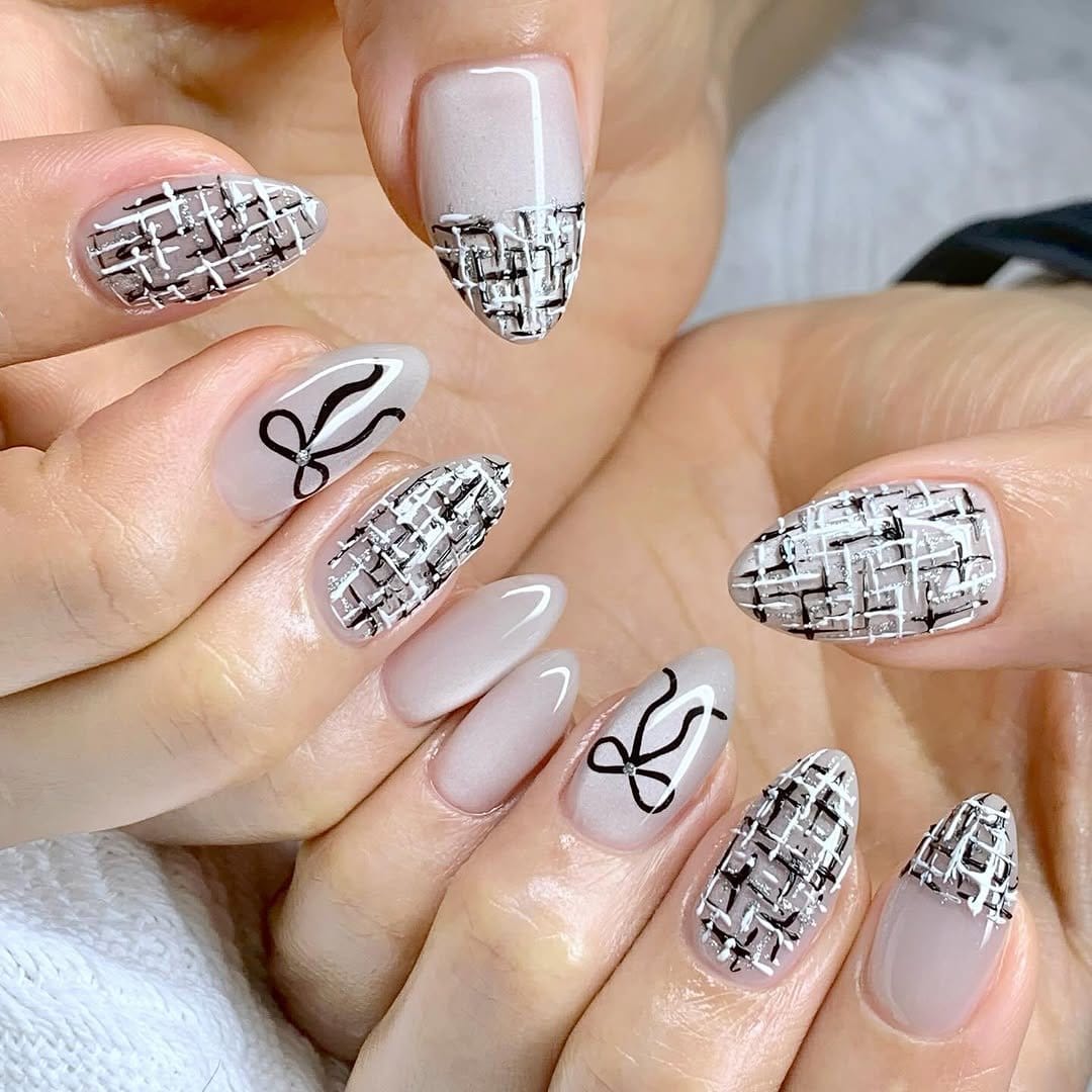 White nails with geometric glitter patterns
