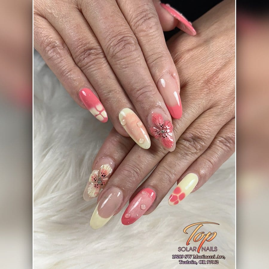 Vibrant pastel coral ombre nails in sunlight