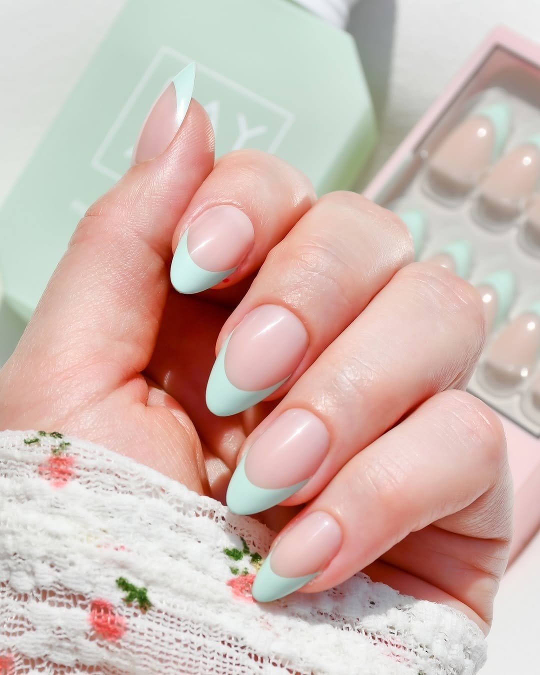 Soft pistachio green French tips with almond shape