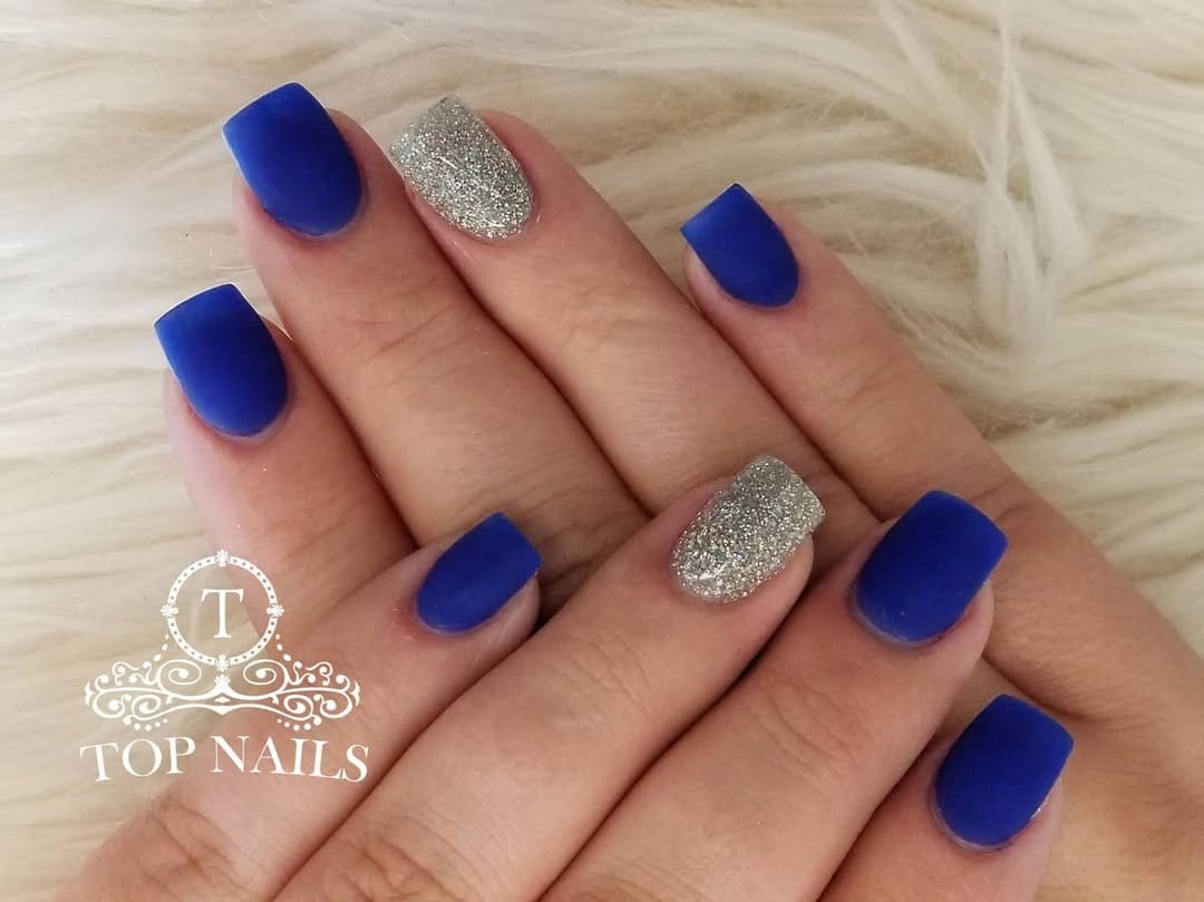 Soft blue nails with silver star accents